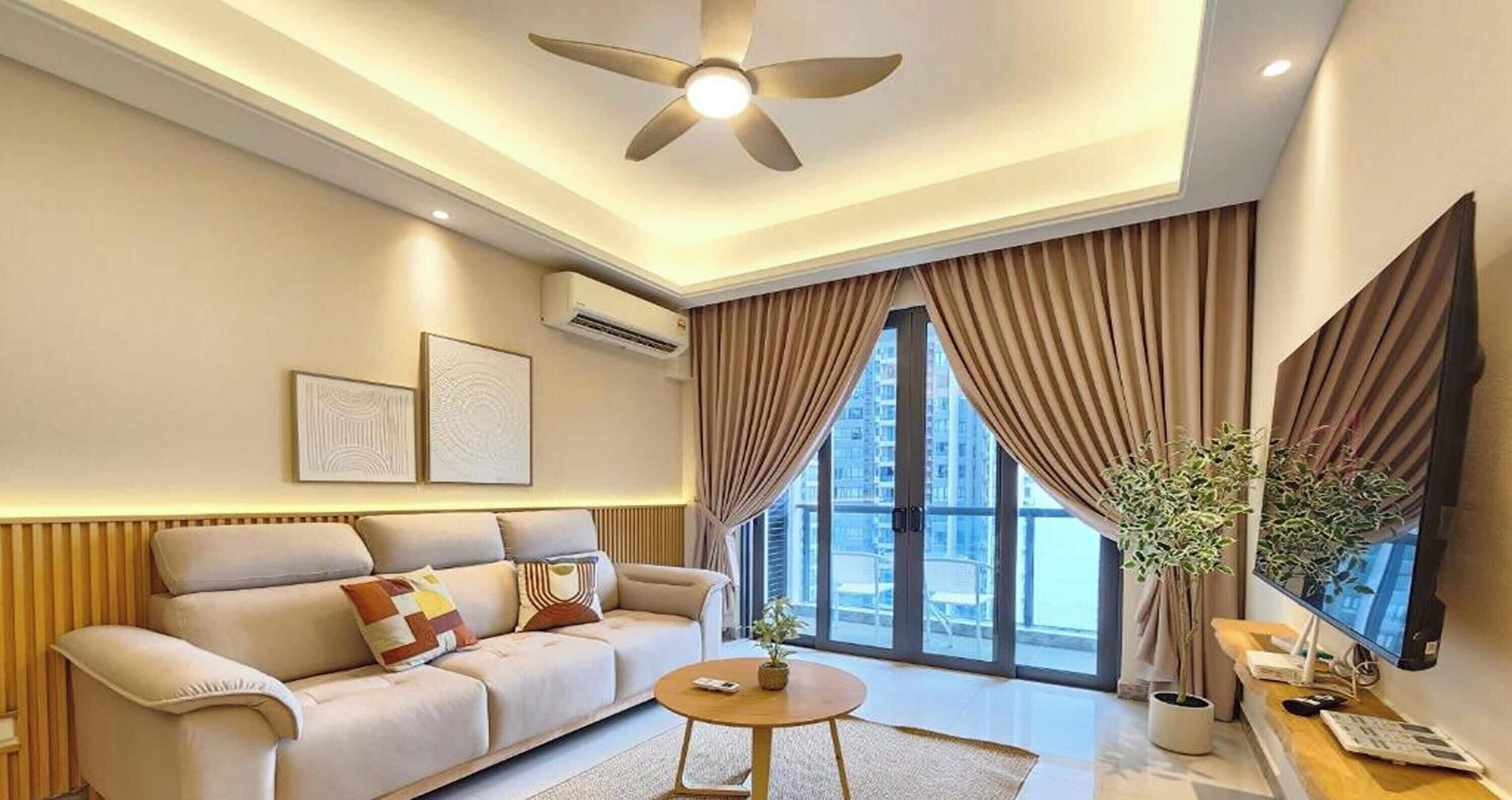 A modern living room with a sofa, a coffee table, a ceiling fan, and a large window with curtains.