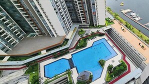 A high-rise building with a rooftop pool and marina. - R&F Princess Cove Designer Suites By Neo (Johor Bahru)