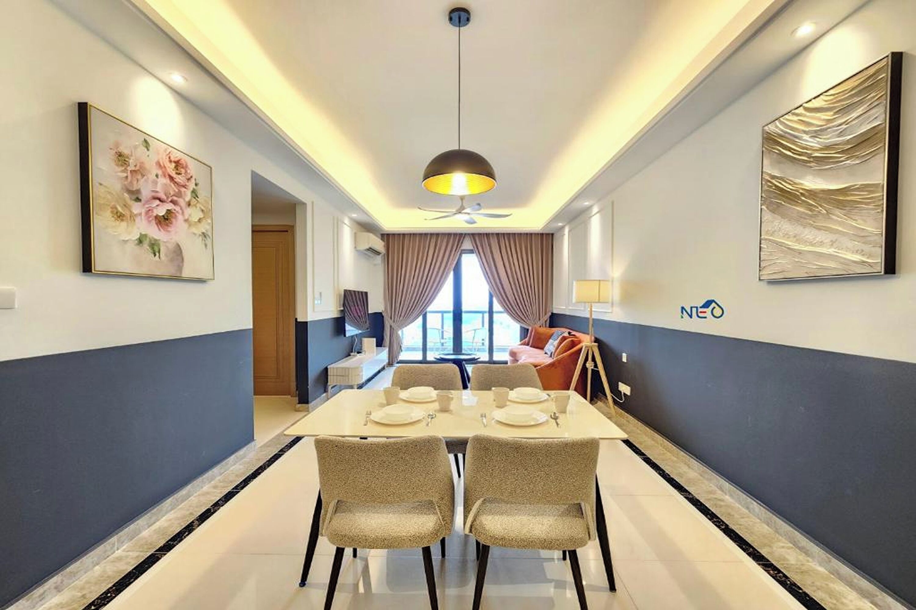 A hotel room with a dining area, a ceiling fan, a large window with curtains, and a wall-mounted artwork.