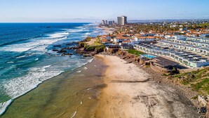 A coastal town with a beach, residential buildings, and a pier. - Dog-friendly villa with heated pool, hot tub, streaming, partial ocean views (Rosarito)