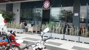 A coffee shop with a sign reading 'RIO COFFEE AND RESTAURANT' and a clock above the entrance. - Kindaruma Homes Apartments (Nairobi)