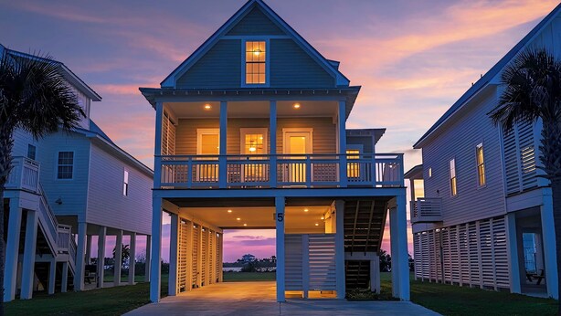 A two-story house with a balcony, a covered porch, and a garage.
