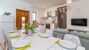 A modern kitchen with white cabinets, a built-in oven, and a microwave. - Holiday apartment with swimming pool, playground and barbecue (Valbandon)