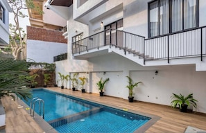 A modern building with a swimming pool, potted plants, and a staircase. - Casa Solana 4bhk Villa w Private Pool nr Candolim (Candolim)