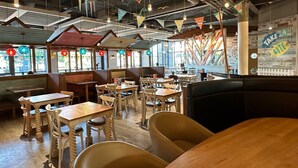 A restaurant interior with booths, tables, and hanging decorations. - Sea Breeze-A Beautiful 3 Bed,Pet Friendly Retreat (Mablethorpe)