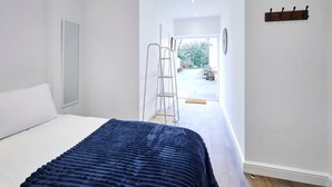 A bedroom with a bed, a ladder, and a view of the outside. - Host Stay The Stables Apartment 1 (Saltburn-by-the-Sea)