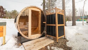 A wooden sauna structure with an open door, a wooden bench, and a small wooden platform. - King Room Near Hiking White Mountains (Bethlehem)