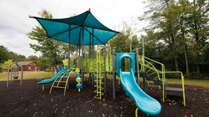 A playground with slides and climbing structures. - King Room Near Trails White Mountains Resort (Bethlehem)
