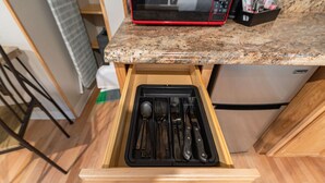 A kitchen with a drawer containing utensils, a microwave, and a refrigerator. - King Room Near Trails White Mountains Resort (Bethlehem)