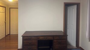 A room with a wooden desk, a white door, and a hallway. - Room-pillais B & B, Private Room Attach (Albany)