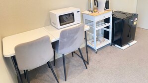 A kitchenette with a microwave, toaster, and refrigerator. - Fabulous residence in New Plymouth (New Plymouth)