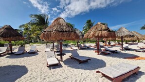 A beach with sun loungers and thatched umbrellas. - Beautiful PH in Front of the Marina (Punta Sam)