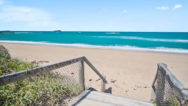 A beach with a wooden walkway leading to the shore. - Splash at Sapphire - Pet Friendly, Resort Pool, Beachfront (Coffs Harbour)