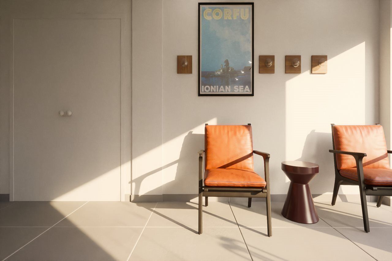 A room with two leather chairs, a small round table, and a poster on the wall.