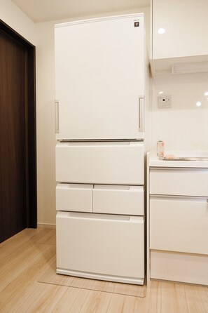 A white refrigerator with a freezer compartment on top, a built-in oven below, and a water dispenser on the right side. - 【5BR Luxury Living】 130㎡DesignerHouse-5BR Luxury Living, Family Roppongi Akasaka (Tokyo)
