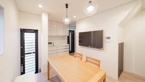 A modern kitchen with white cabinets, a wooden dining table, and pendant lights. - 【5BR Luxury Living】 130㎡DesignerHouse-5BR Luxury Living, Family Roppongi Akasaka (Tokyo)