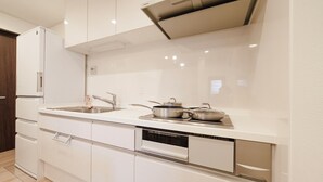 A modern kitchen with white cabinetry, a built-in oven, and a dishwasher. - 【5BR Luxury Living】 130㎡DesignerHouse-5BR Luxury Living, Family Roppongi Akasaka (Tokyo)