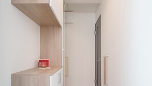 A narrow hallway with a built-in wooden shelf, a door, and a pair of slippers on the floor. - 【5BR Luxury Living】 130㎡DesignerHouse-5BR Luxury Living, Family Roppongi Akasaka (Tokyo)