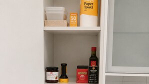 A kitchen with a toaster, a microwave, a coffee maker, and a trash bin. - Coastal Retreat with Private Verandah -
King Bed - Walk to Beach & Train (Adelaide)