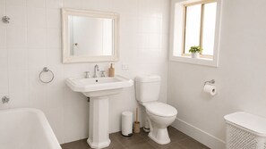 Ein Badezimmer mit Waschbecken, Toilette und Badewanne.