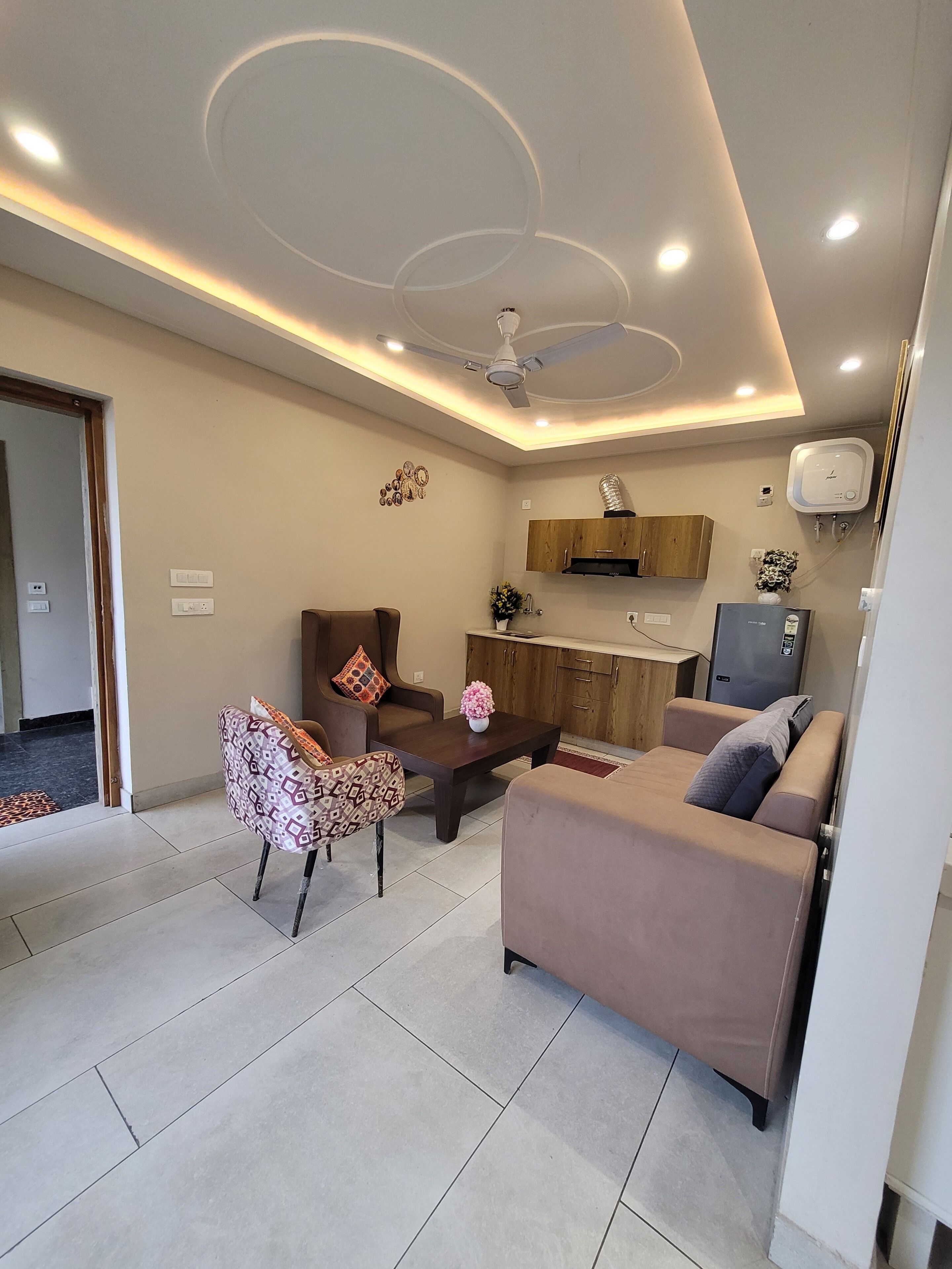 A modern living room with a sofa, a coffee table, and a TV.