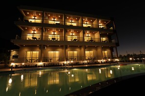 A multi-story hotel with balconies, a swimming pool, and outdoor seating areas. - Ritz Valley Resort (Mahabaleshwar)