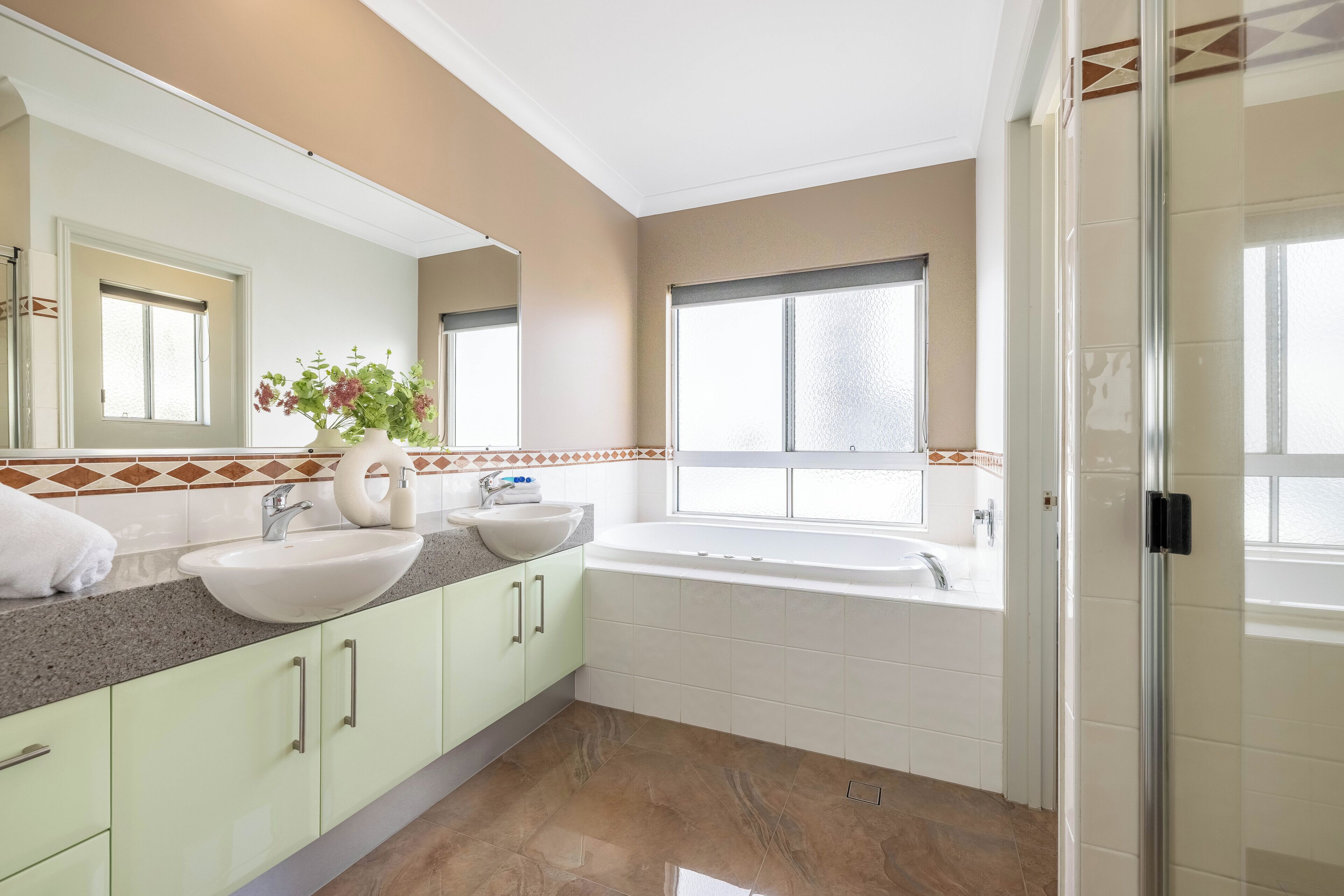 A modern bathroom with a large sink, a bathtub, and a shower area.
