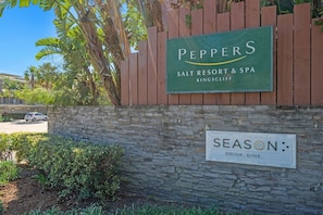 A sign for 'Peppers Salt Resort & Spa Kingscliff' and a 'Season: Drink. Dine.' sign. - The Sand Resort | Coastal One Bedroom with park view (Tweed)