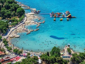 Eine Küstenlandschaft mit Strand, Booten und einem Wasserpark.