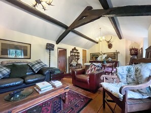 A cozy living room with a sofa, armchair, and a coffee table.