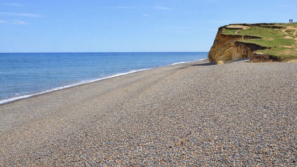 A pebbled beach with a cliff and ocean. - 1 bedroom accommodation in Weybourne (Weybourne)