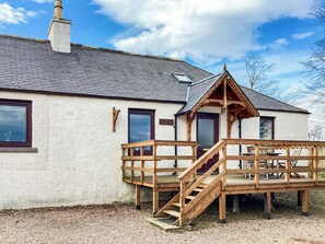 A building with a wooden deck, a staircase, and a door. - Gardeners Cottage - UK51548 (Auchterless)