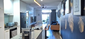 A modern kitchen with a dining area, a sofa, and a view of the city. - A perfect place to hide away with river side charm (Balmoral)