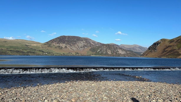 A lake with mountains in the background and a rocky shoreline. - Lakes House Frizington, Cumbria (Cumberland)