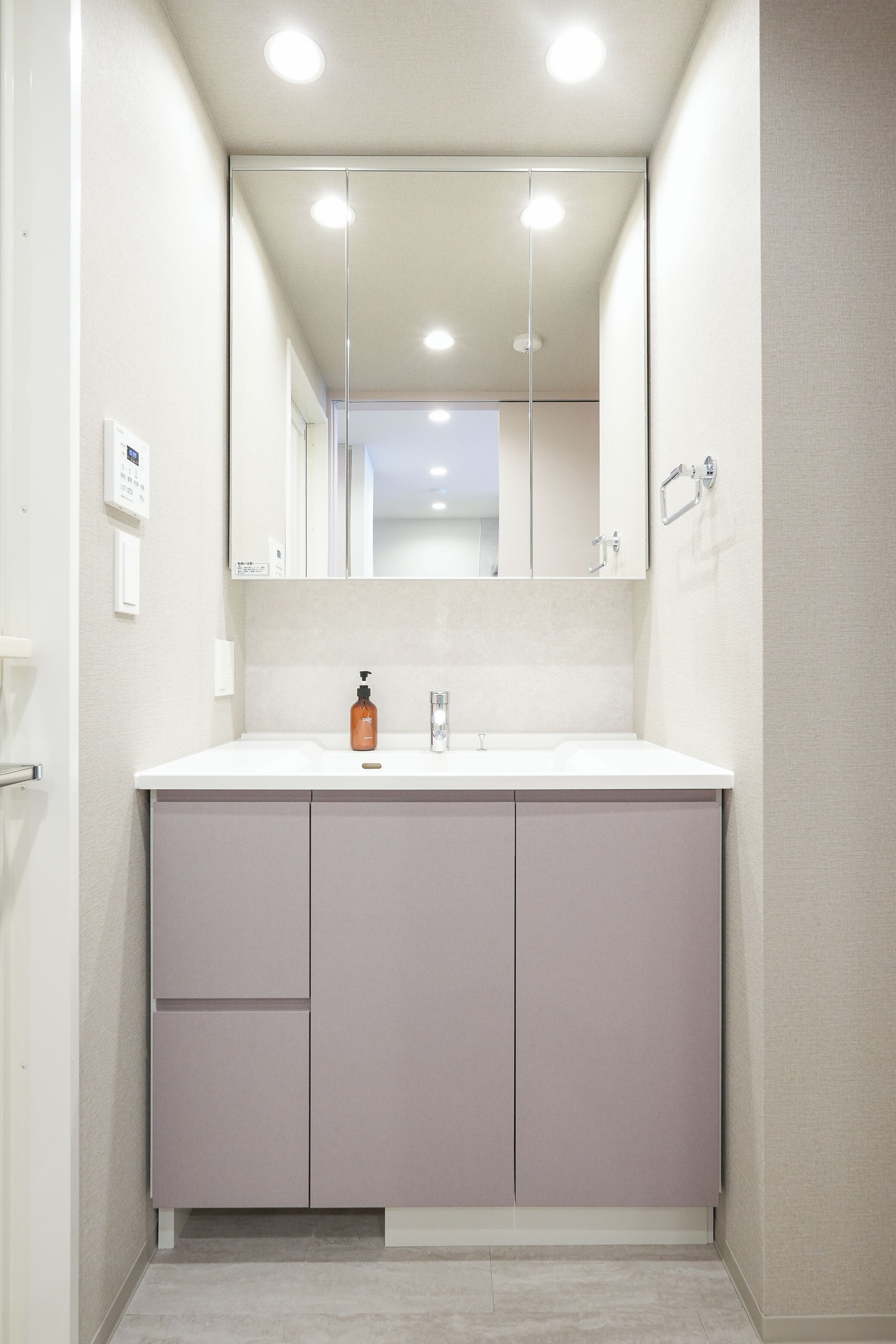 A bathroom with a white sink, a mirror, and a cabinet.