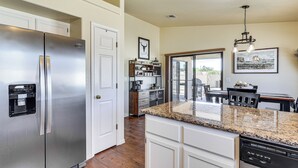 A kitchen with stainless steel appliances, white cabinetry, and a granite countertop. - Desert Escape w/ Spool Pool! 4 Mi to Lake Havasu (Lake Havasu City)