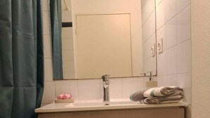 A bathroom with a sink, mirror, and two drawers. - Studio Rangueil Close to hospitals and universities Free parking (Toulouse)
