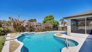 A swimming pool with a curved edge, surrounded by a concrete deck and a covered patio area. - Jump Into Fall at This Cozy Gem w/ Private Pool! (Palm Bay)