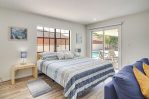 A bedroom with a bed, a desk, a chair, a pool view, and a balcony. - Pool Access! Snowbird Gem in Country Club of Miami (Hialeah)