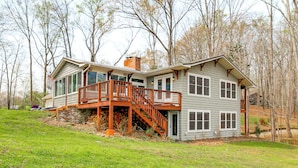 A two-story house with a wooden deck, large windows, and a chimney. - Bring Your Boat! Waterfront Stay on Tims Ford Lake (Estill Springs)