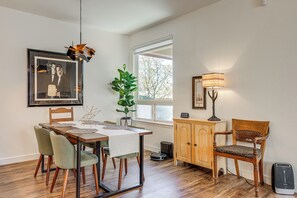 A dining area with a table, chairs, a potted plant, a cabinet, and a window with a view. - 7 Mi to Dtwn! Family Retreat w/ Patio in Denver (Denver)