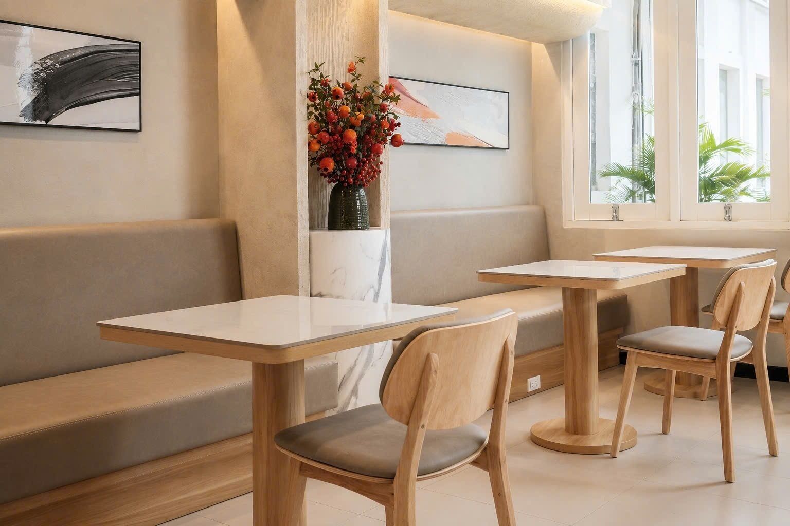 A modern interior with seating, tables, and artwork.