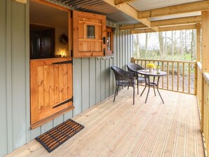 A wooden deck with a table and chairs, a wooden cabinet, and a view of the outdoors. - Bracken Fern, Eppleby (Richmond)