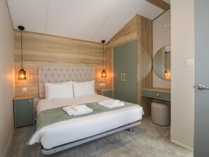 A bedroom with a bed, two bedside tables, a nightstand, a mirror, and a wardrobe. - Owl, Shobdon Herefordshire (Leominster)