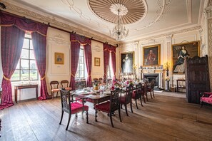 A formal dining room with a long table set for a meal, ornate ceiling, and classical paintings. - Lytham Hall Gate House, Lytham St. Annes (Lytham St. Annes)