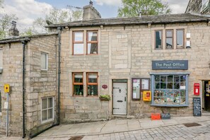 A stone building with a sign reading 'The Post Office.' - Weavers Cottage, Heptonstall (Hebden Bridge)