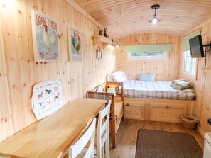 A cozy wooden room with a bed, a desk, and a window. - Shepherds Retreat Glenlark - Cozy Getaway (Omagh)
