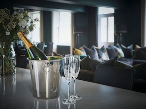 A bottle of champagne in a metal bucket with two glasses on a table. - Edgar House, Chester, Cheshire (Chester)