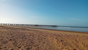 A beach with a pier extending into the water. - Vacation home 250 m from the beach and forest. (Saint-Jean-de-Monts)