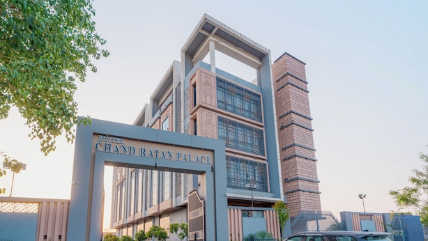 A modern hotel entrance with a prominent sign reading 'Hotel Chand Ratan Palace.'